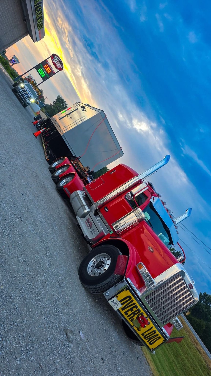 Black Maxx red truck with oversized load